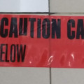 under ground warning tape caution buried electric line below,tanda peringatan